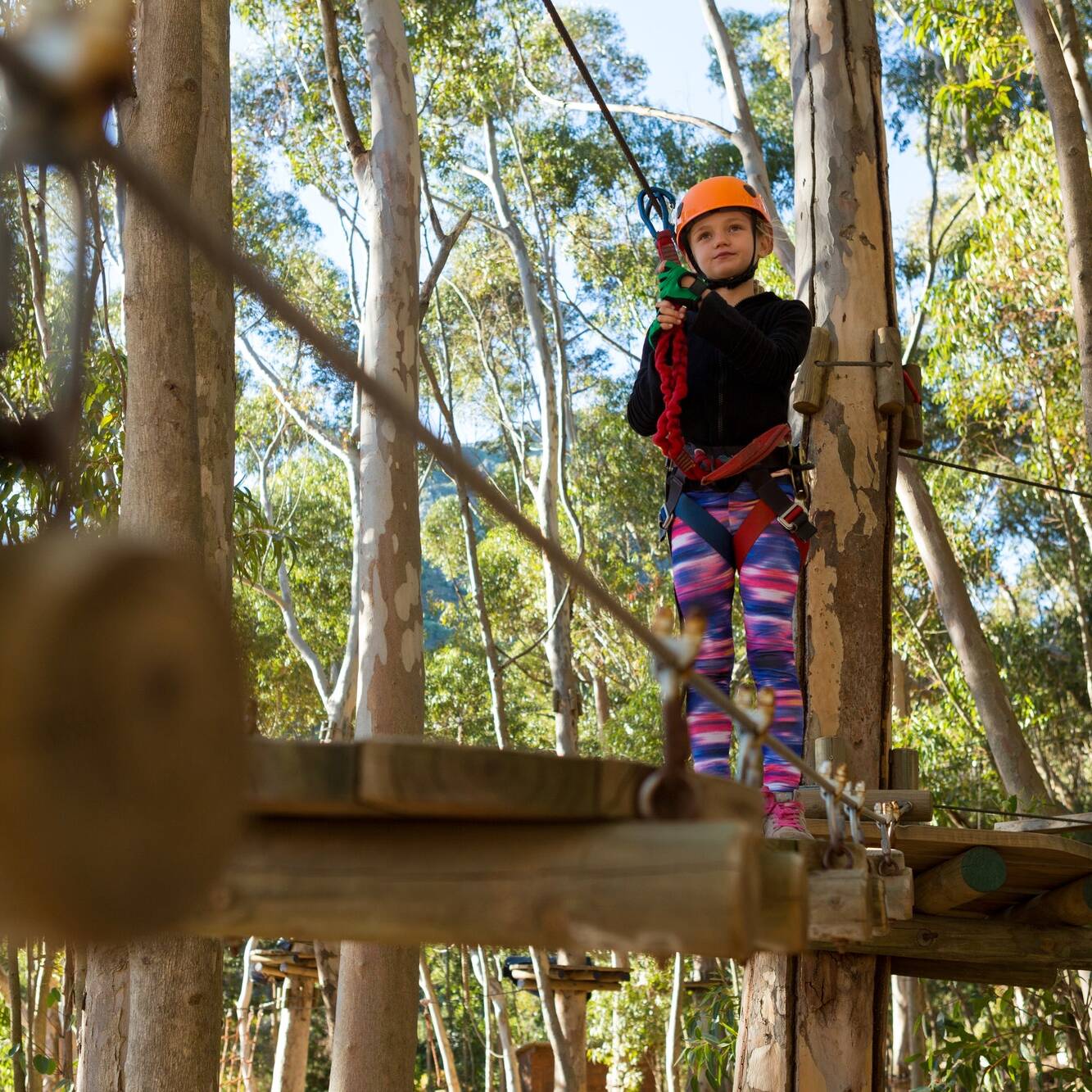 Little girl wearing helmet getting ready to ride